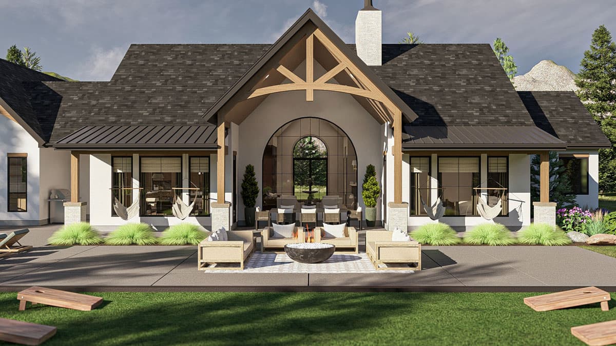 House plan exterior: Modern Farmhouse style, single story, with a large covered patio, arched entryway, and exposed wooden beams.