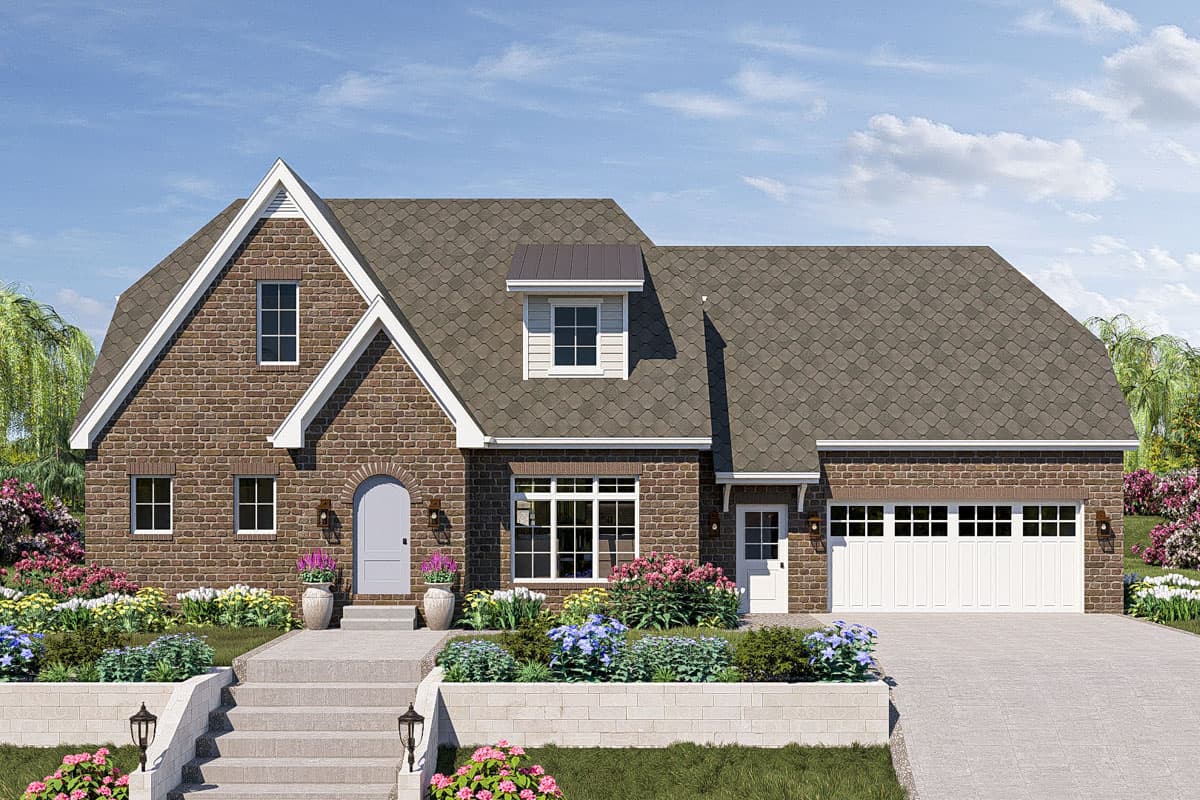 House plan exterior. Two-story brick home with gabled roof, dormers, and attached garage. Stone staircase leads to arched front door.