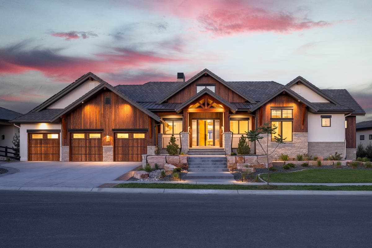House plan exterior with Craftsman style, two stories, front-facing gables, wood garage doors, and a covered entry porch.