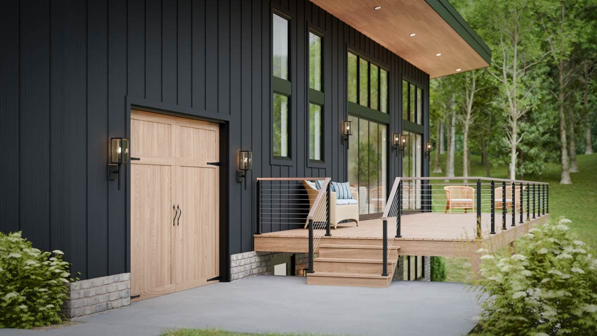Modern house plan exterior with vertical siding, wood garage door, large windows, and a tiered deck with cable railings.