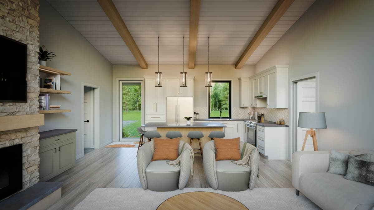 Open concept living area with vaulted beamed ceiling, stone fireplace, kitchen island with seating, and modern white cabinetry.