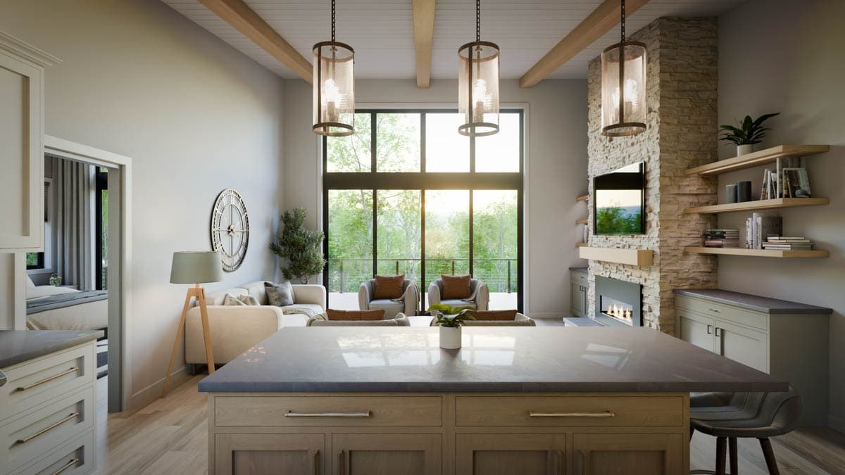 Open-concept living area with kitchen island, stone fireplace, large windows, and exposed wood beams.