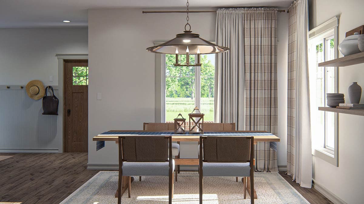 Dining room with wooden table, chairs, pendant light, and a glass-paned wooden door.