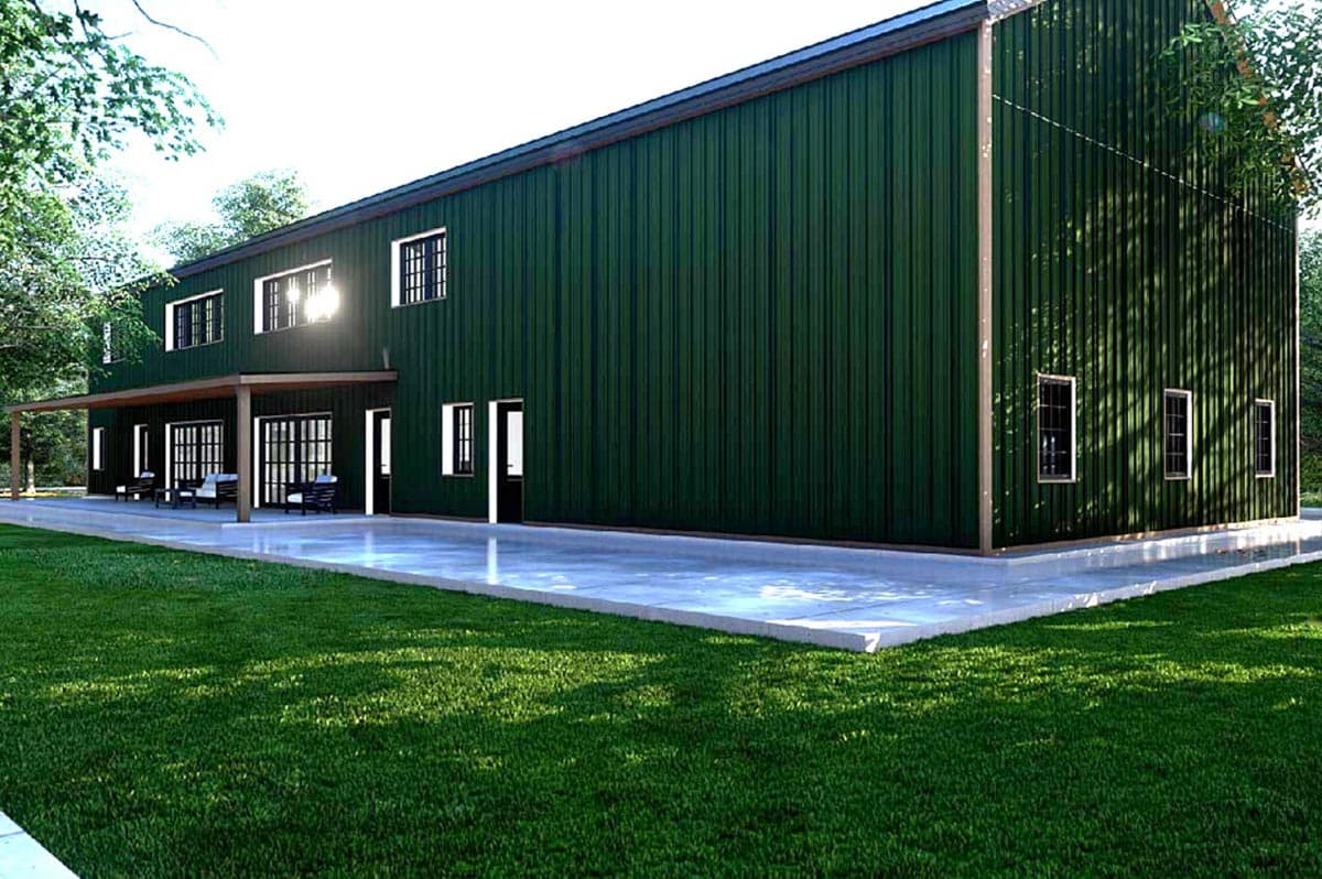 Two-story house plan exterior with dark green vertical metal siding, covered patio with outdoor seating, and a large concrete patio.