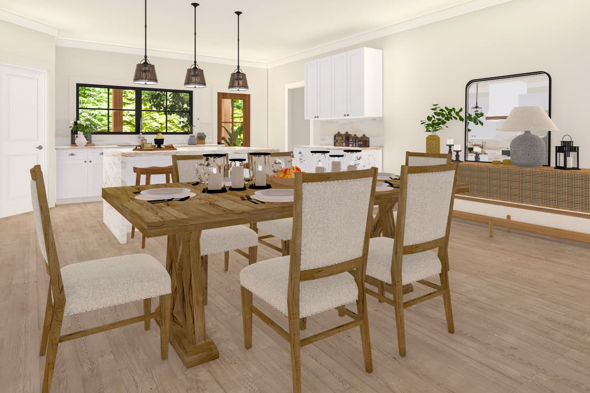 Dining room with island and kitchen view, featuring a rustic wood table, upholstered chairs, and pendant lighting.