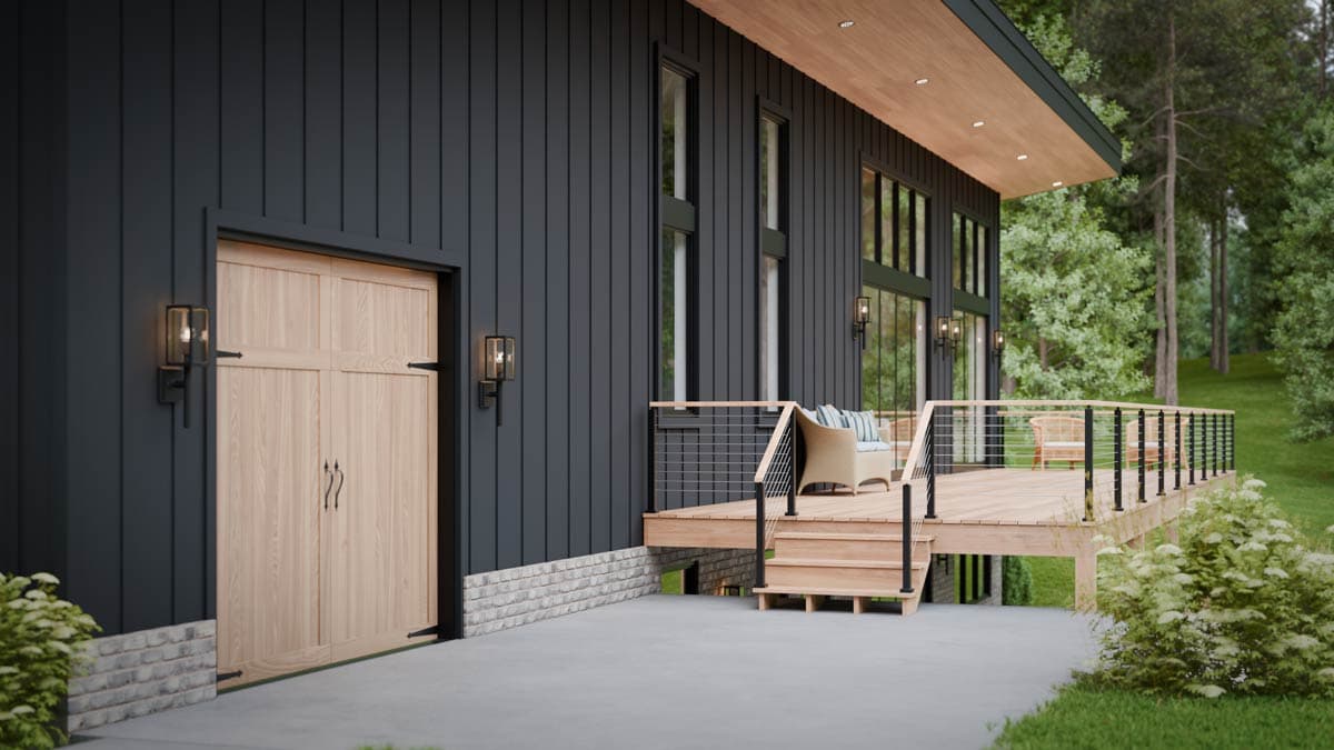 Modern house plan exterior with dark vertical siding, wood garage door, large windows, and a wooden deck with cable railing.