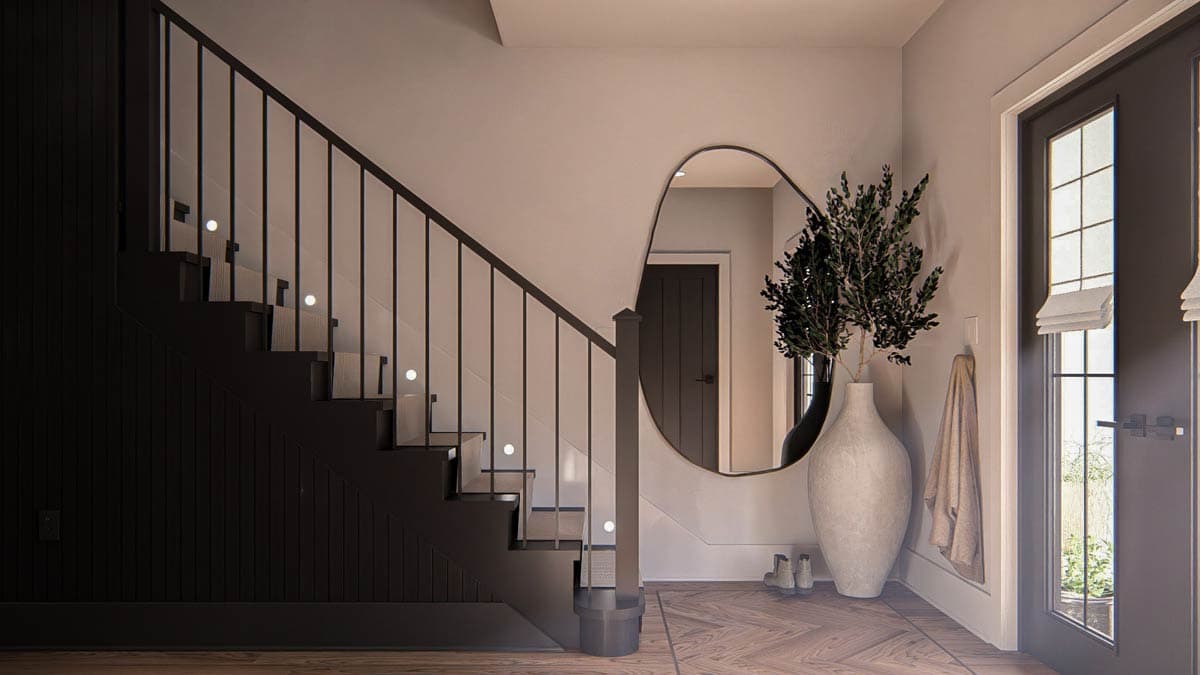 Interior view of a modern staircase with black railings, LED step lights, beadboard wainscoting, and a large arched mirror.