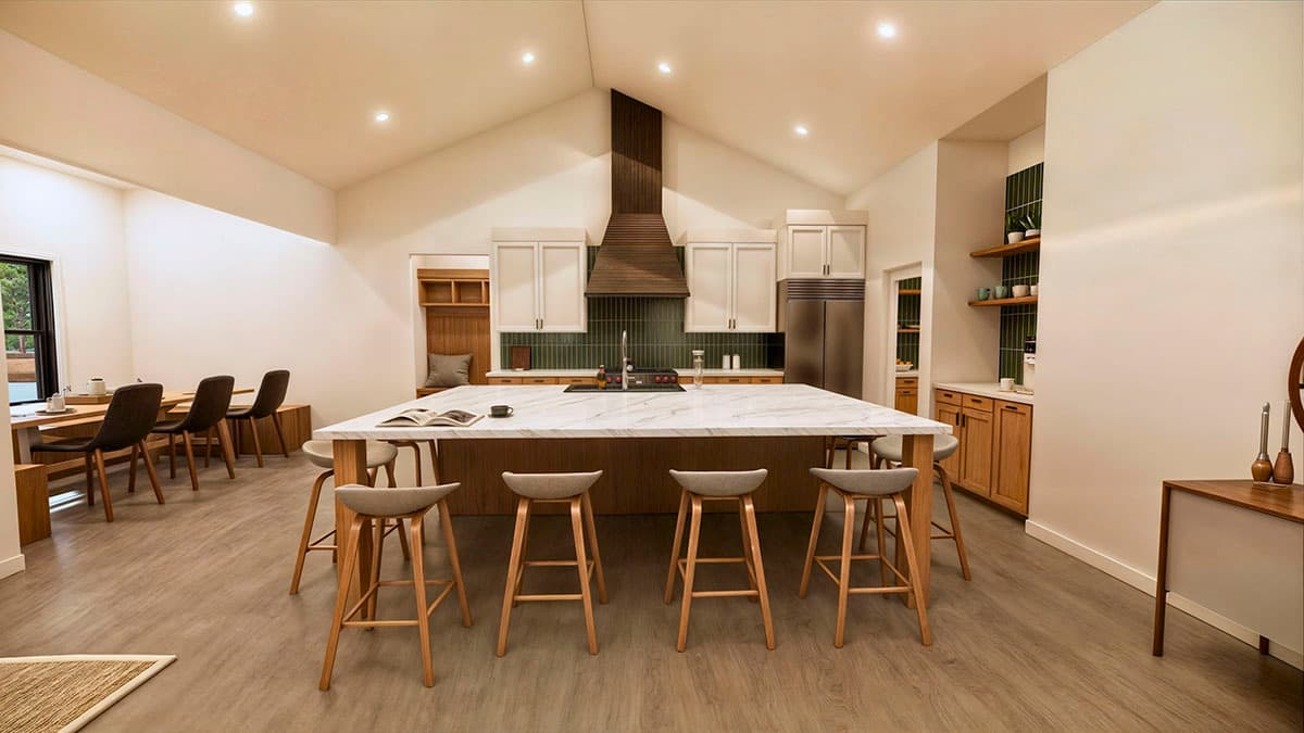 A modern, open-concept kitchen with a large marble island and bar stools, leading to a dining area with a long table and chairs.