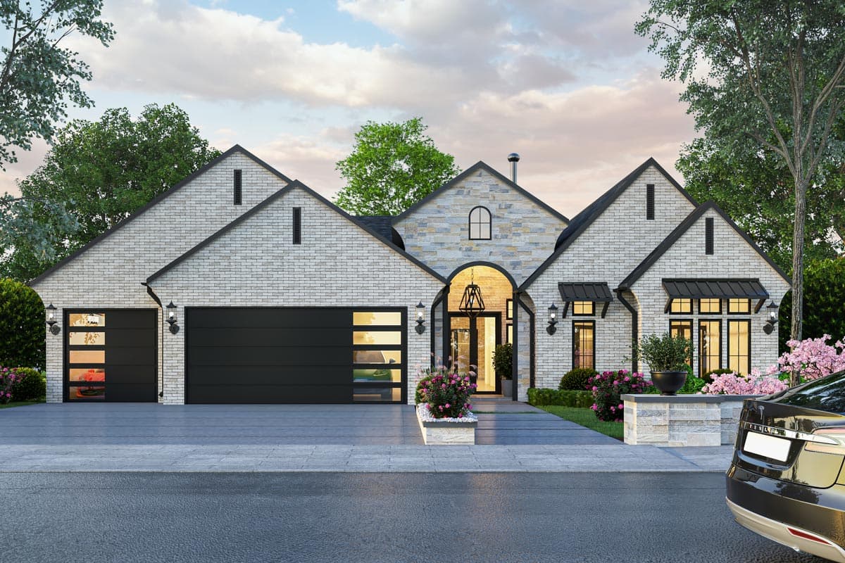 House plan exterior with two-story design. Features include brick facade, gabled rooflines, arch entry, and attached garage.