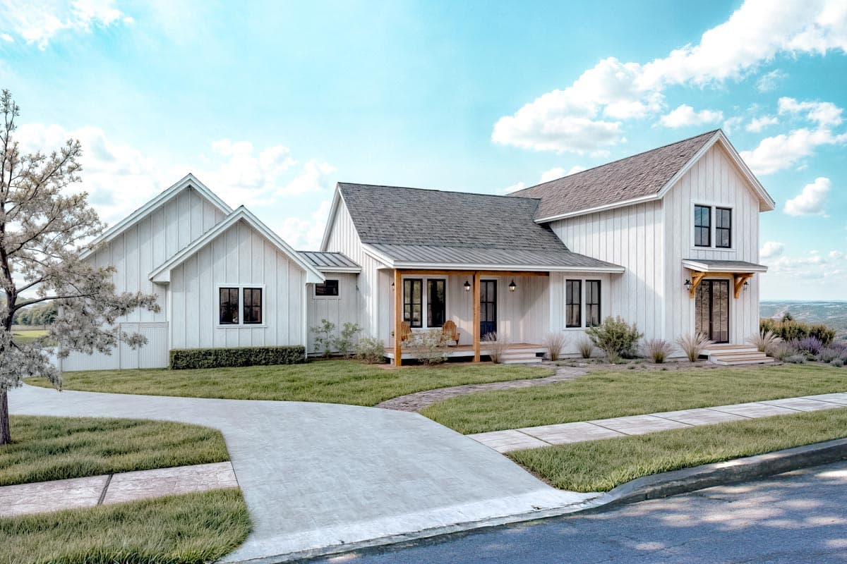 A modern farmhouse with white siding and black trim is set on a grassy lawn with a curved walkway leading to the front porch.