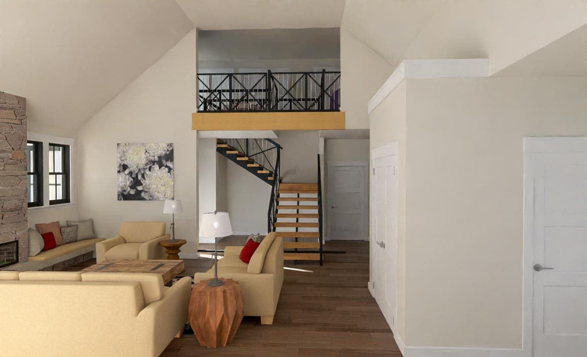Open-concept living room with a loft and staircase. Light-colored walls, wood floors, and neutral furniture create a spacious feel.