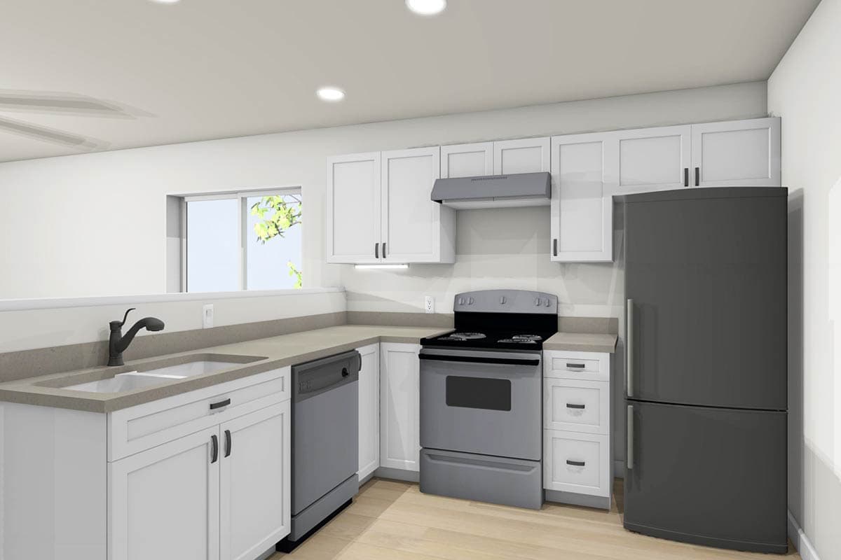 A modern kitchen with white cabinets, gray appliances, and a dark refrigerator. The sink and stove are positioned in a corner.