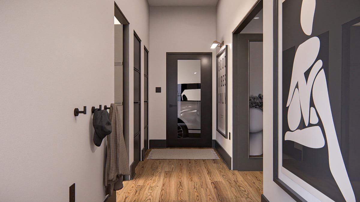 Interior view of a modern entryway with a glass-paneled door to a garage, coat hooks, and abstract art.
