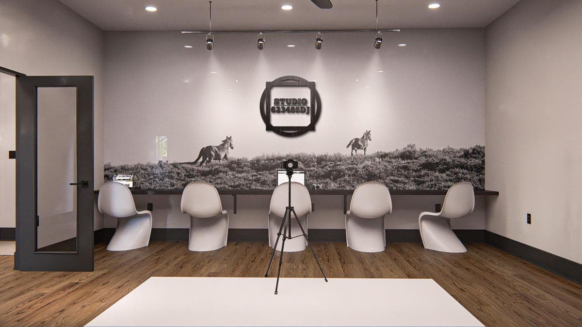 Interior view of a waiting area with five chairs, a desk, a camera on a tripod, and a mural of horses and landscape.