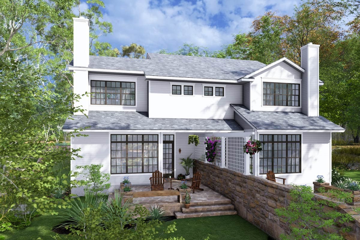 House plan exterior: Two-story white home with gabled roof, prominent chimneys, front porch, and large grid windows.