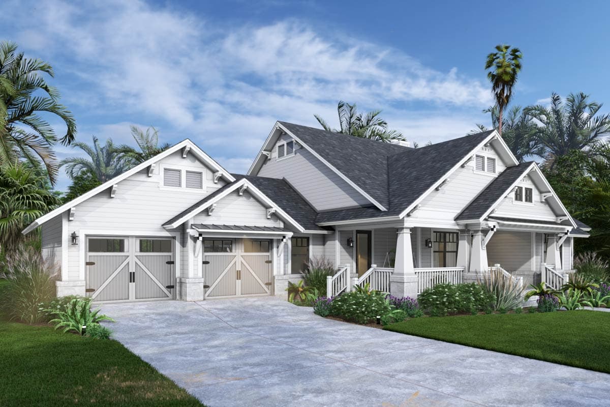 A white, two-car garage home with a dark gray roof sits on a concrete driveway. Palm trees and other greenery surround the house under a blue sky.