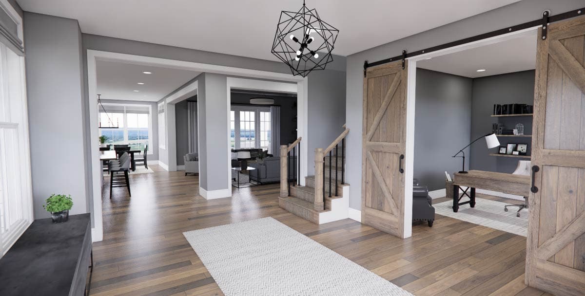 Interior view of a house plan showing a foyer with barn doors, a staircase, and an open view to the dining and living areas.