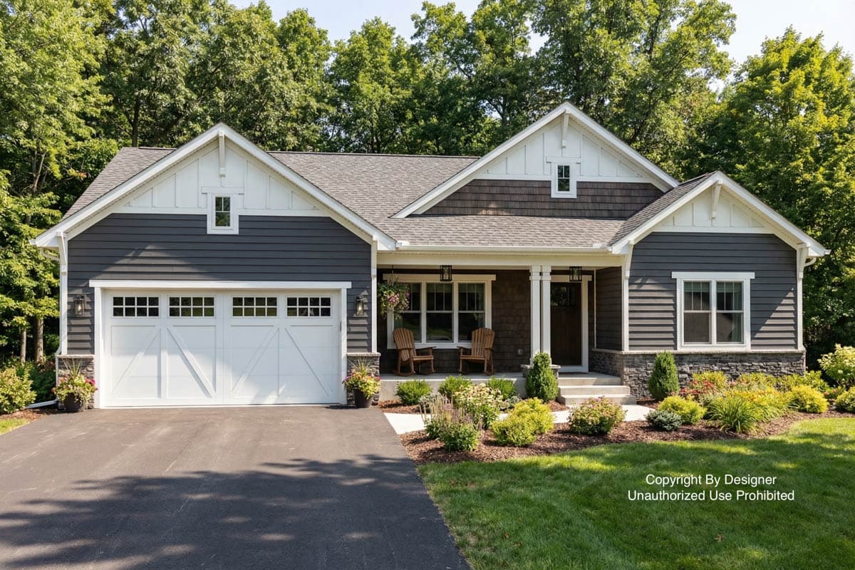 A modern, two-story house with dark gray siding, white trim, and a white garage door sits in front of a green lawn and trees.