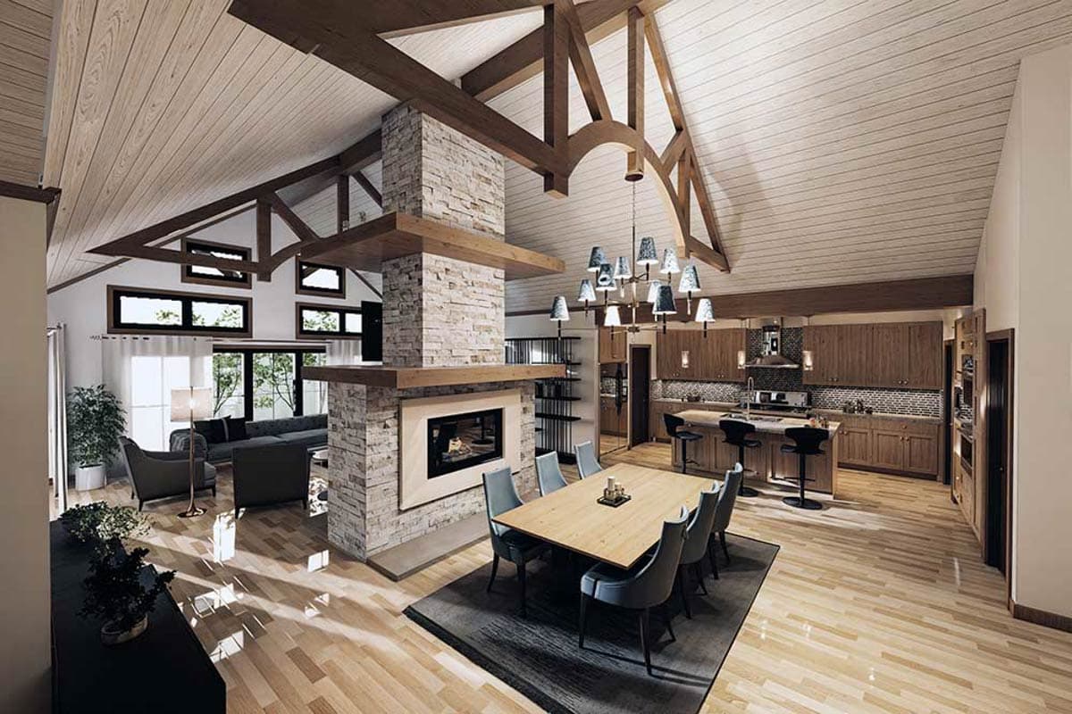 Great room with vaulted beamed ceiling, stone fireplace, dining area, and open kitchen with island.