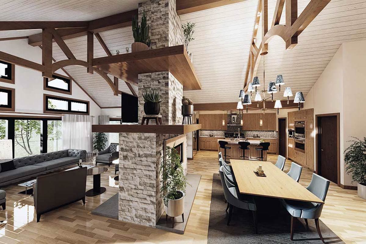 Open-concept living area with vaulted wood-beamed ceiling, stone fireplace, kitchen island, and dining area.