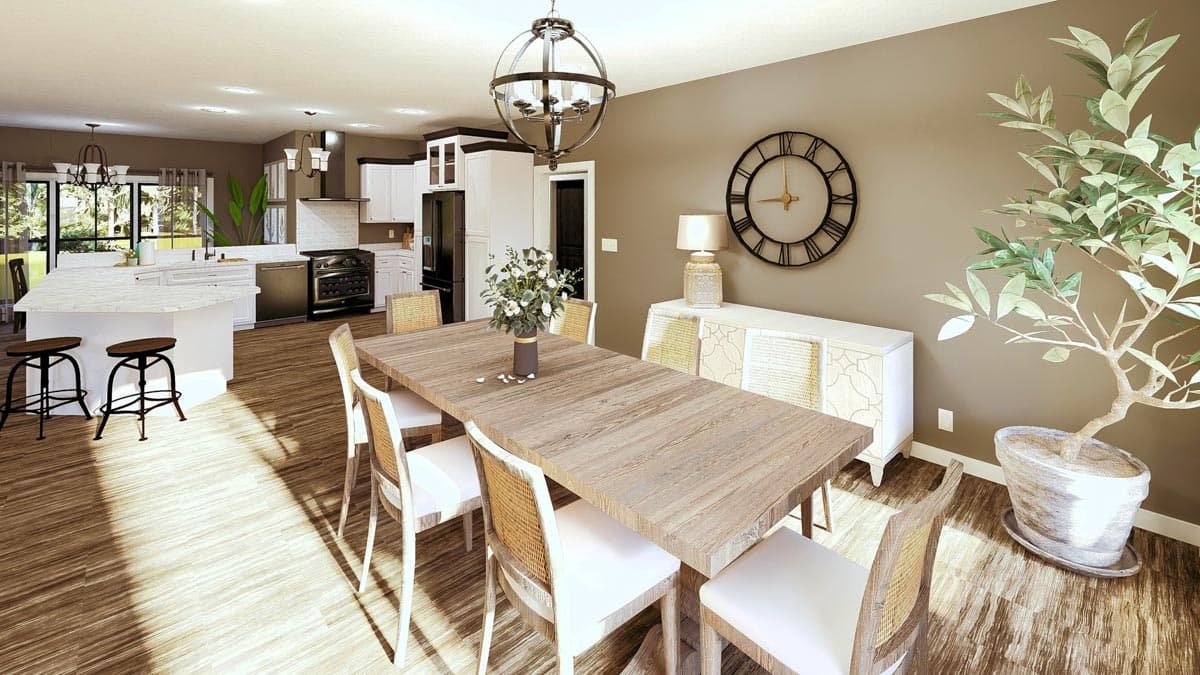 Open-concept dining room and kitchen with large island, dining table, and range.