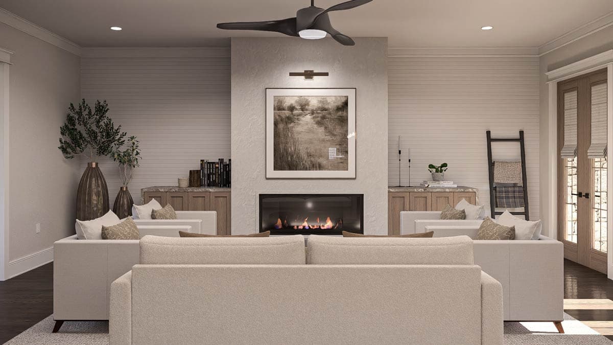 Great room with fireplace, built-in cabinetry, ceiling fan, and double doors.