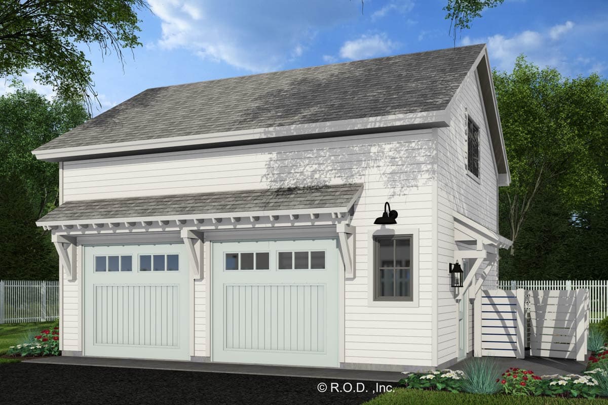 Two-car garage with carriage-style doors, decorative eaves, and a second-story dormer window.