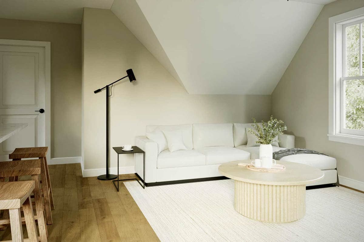 Living area with vaulted ceiling, sectional sofa, fluted coffee table, and large window.