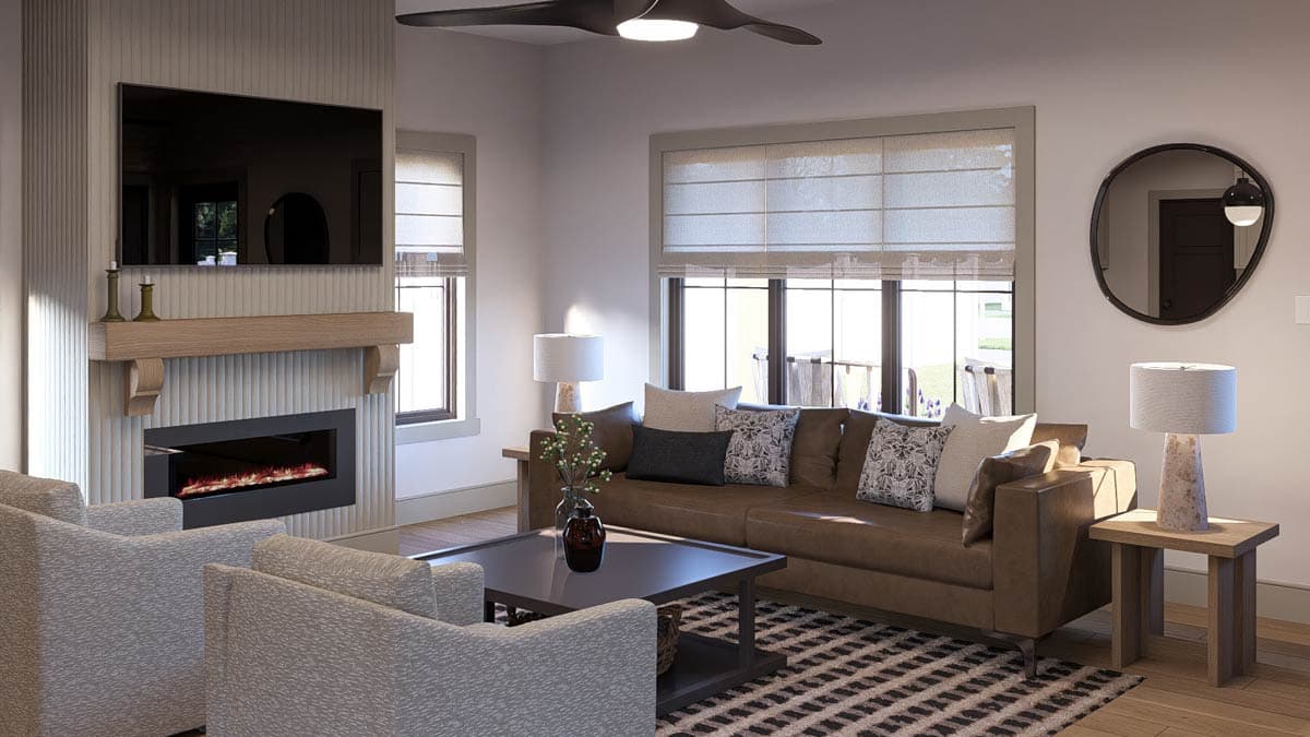Living room with fireplace, leather sofa, patterned rug, and seating. Includes flat-screen TV.
