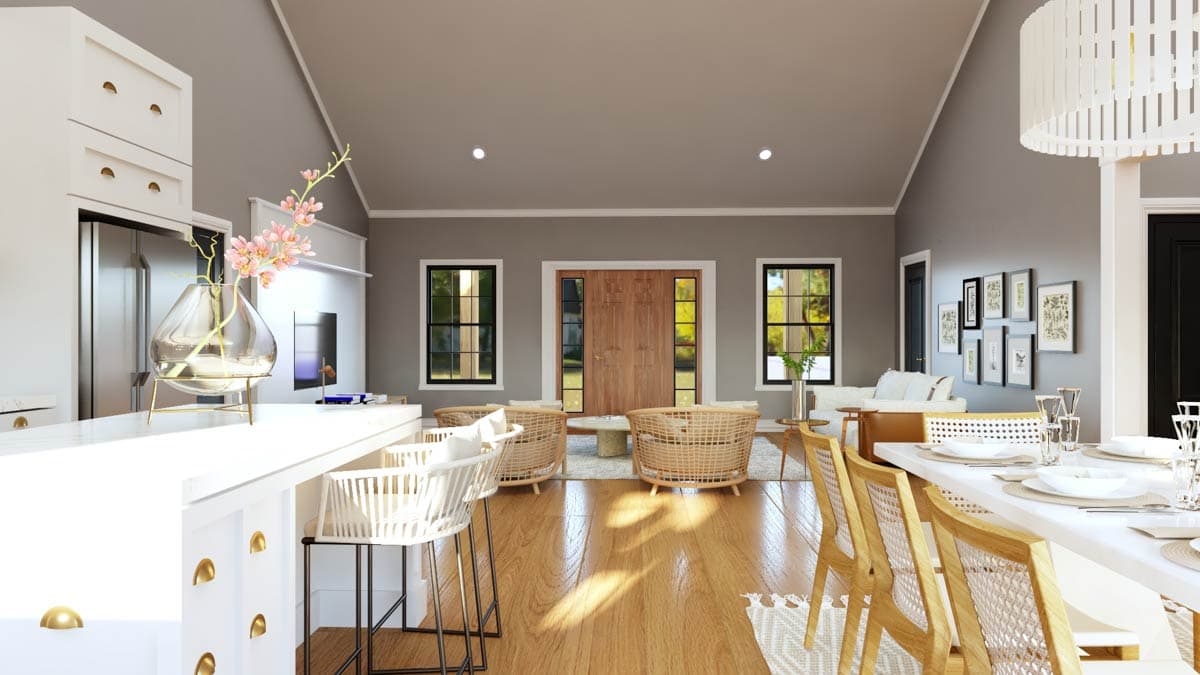 Open concept living and dining area with vaulted ceiling, double doors, and kitchen island.