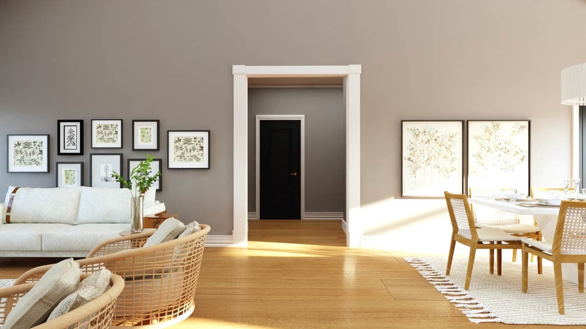 Interior view of living and dining area with gallery wall and black door leading to hallway.