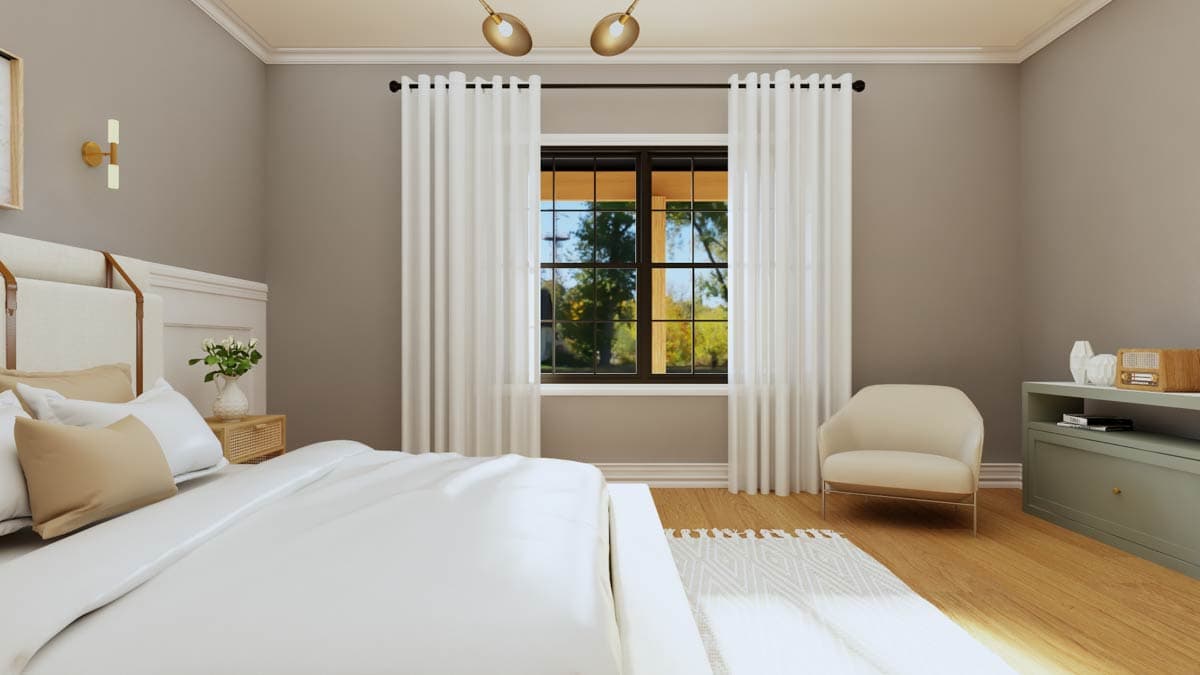 Bedroom with white bedding, upholstered headboard, large window with grid panes, and a single armchair.