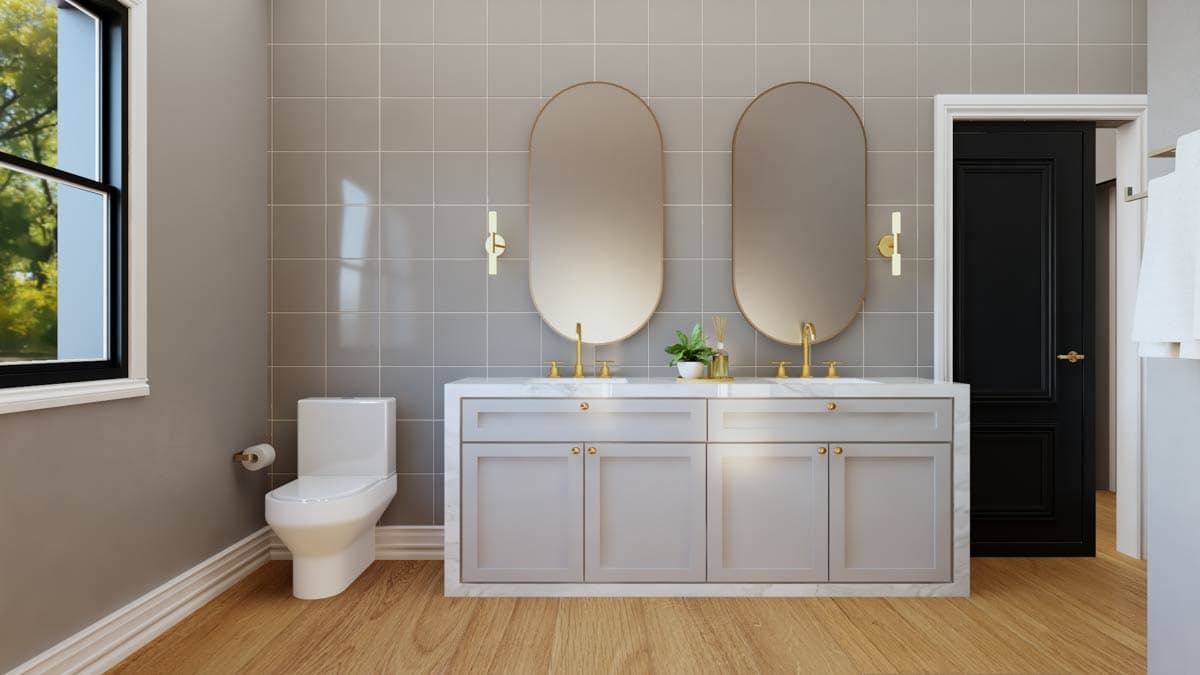 Bathroom interior with dual vanities, twin oval mirrors, toilet, window, and black paneled door.