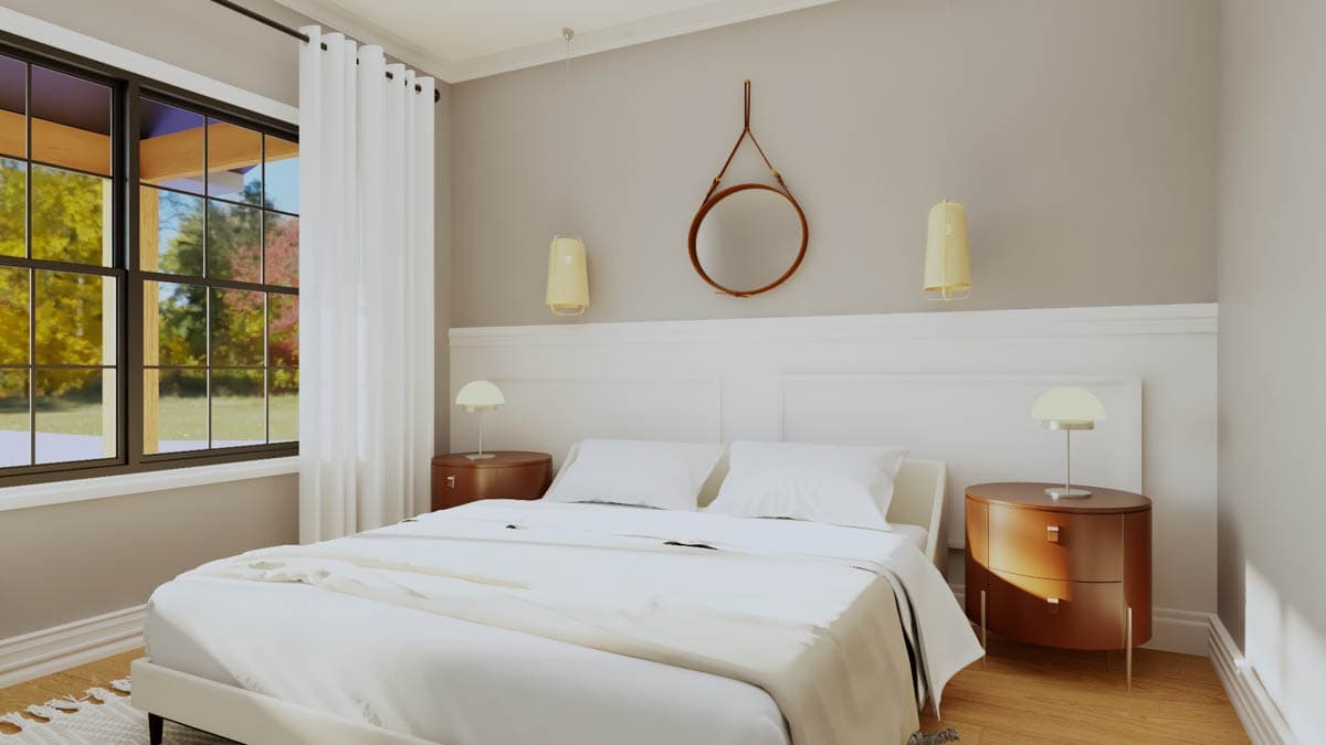 Bedroom interior with a queen bed, two nightstands, and large windows overlooking trees.