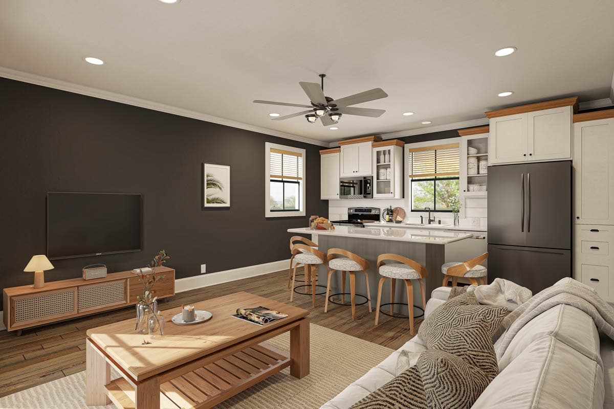 Open concept living area with kitchen island, seating for three, and television.