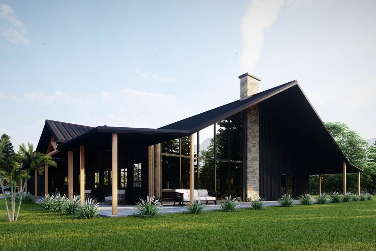 House plan exterior of a modern ranch with a dark facade, a stone chimney, and expansive glass walls overlooking a covered patio.