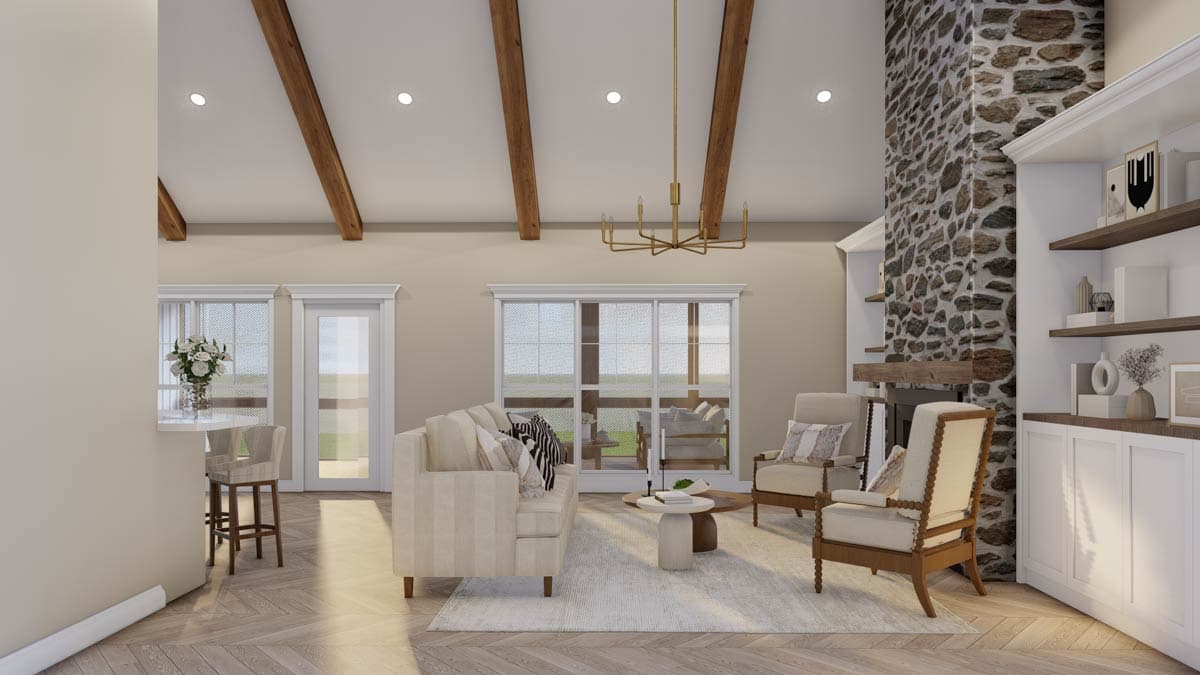 Great room with vaulted, beamed ceiling, stone fireplace, and built-in shelving.
