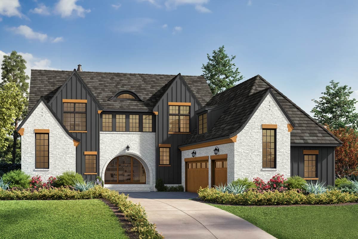 House plan exterior. Two-story Modern Farmhouse with gabled roof, brick facade, arched window, and attached garage with wood doors.