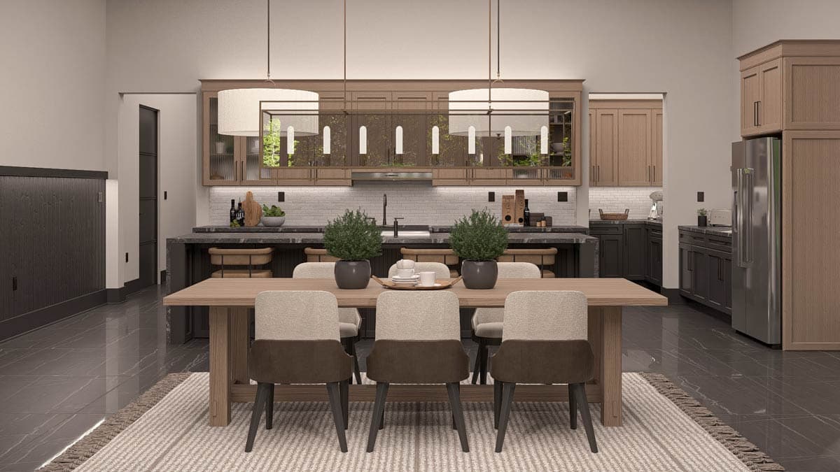Dining area and kitchen with island, wood cabinets, pendant lights, and stainless steel refrigerator.