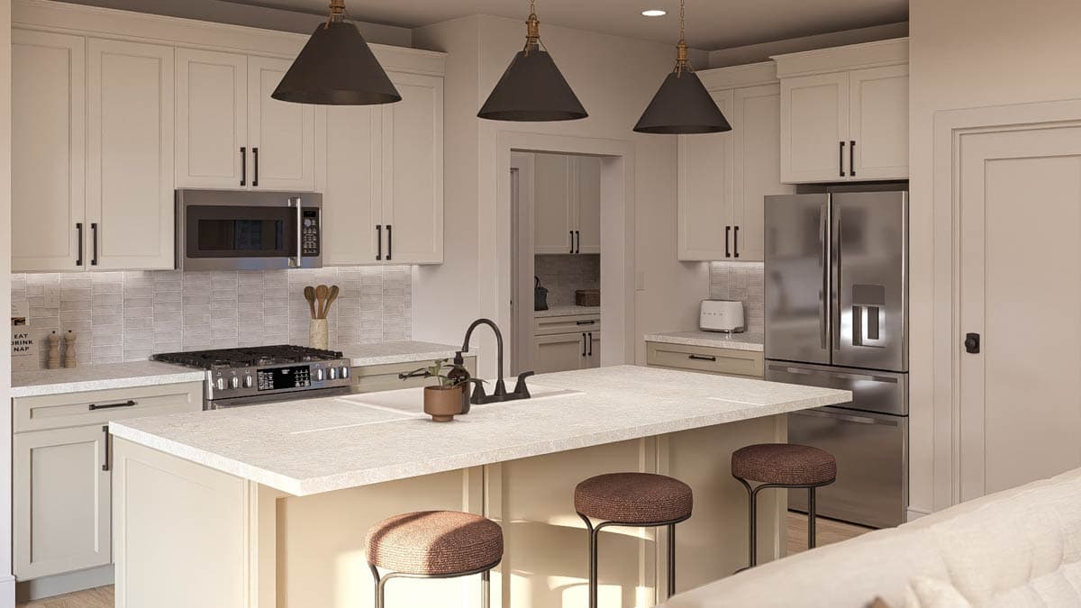 Kitchen interior with island, white shaker cabinets, stainless steel appliances, and pendant lighting.