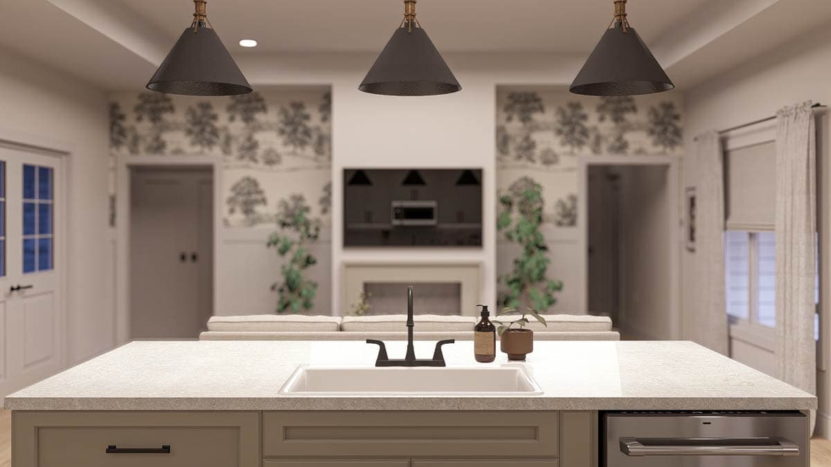 Kitchen island with sink, faucet, and dishwasher, looking toward living room fireplace and television.