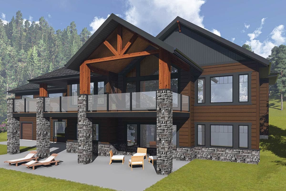 House plan exterior: Modern lodge style with stone pillars, wood beams, multi-level decks, and abundant windows.