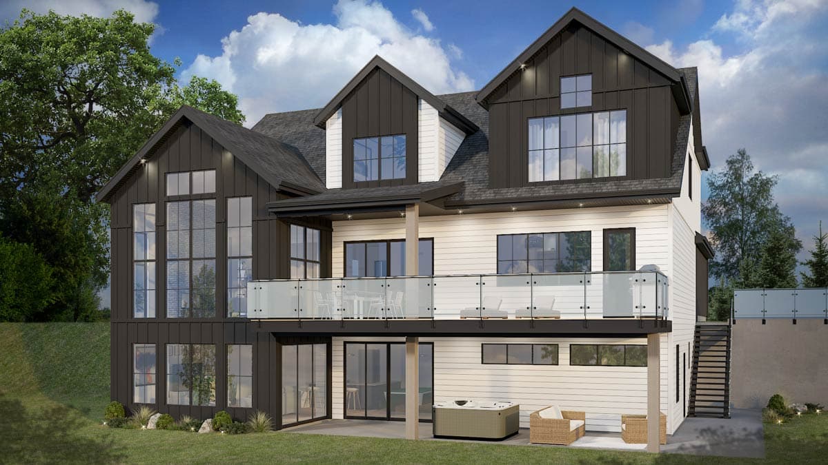 Modern Farmhouse house plan exterior with dark gables, multiple dormers, large windows, and a wraparound deck.