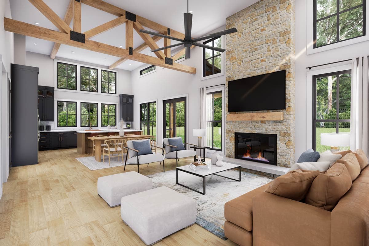 Interior rendering: open great room with vaulted ceiling, exposed beams, stone fireplace, island kitchen, and large windows.