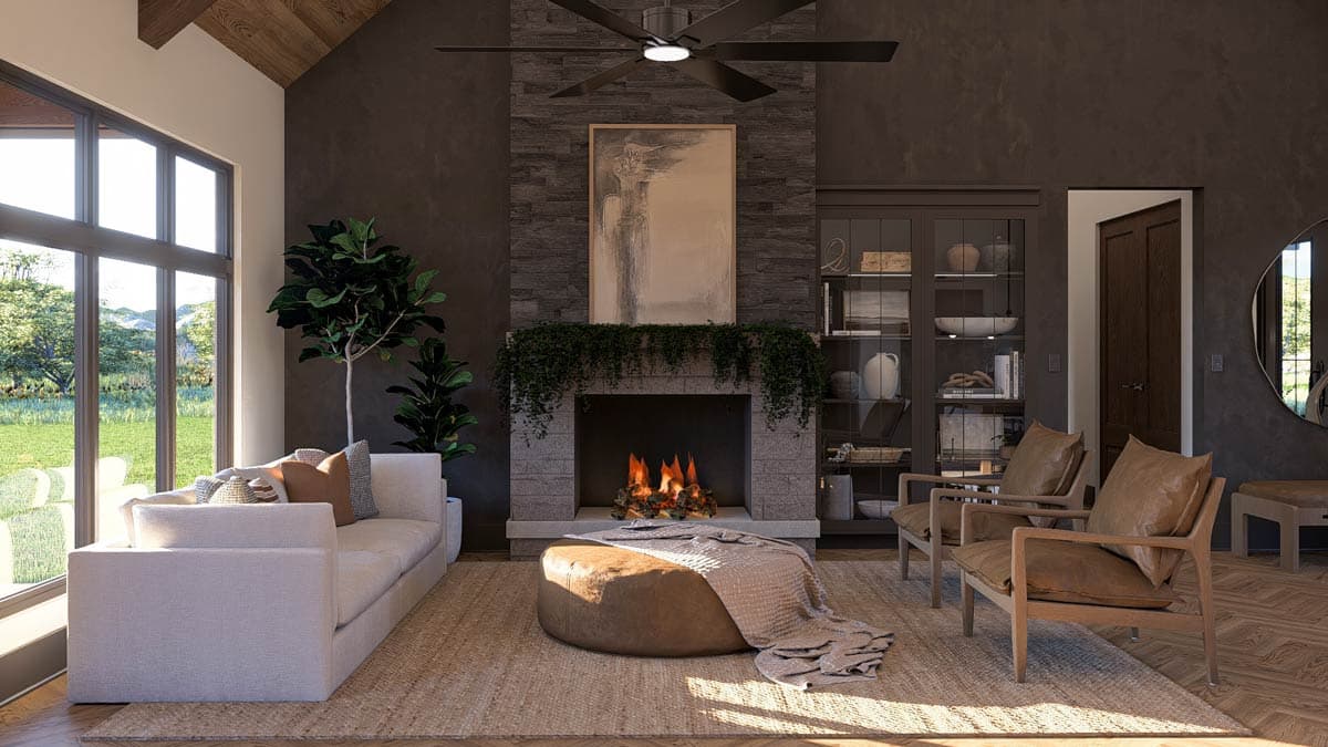 Great room with vaulted ceiling, stone fireplace, large windows, and built-in display cabinet.