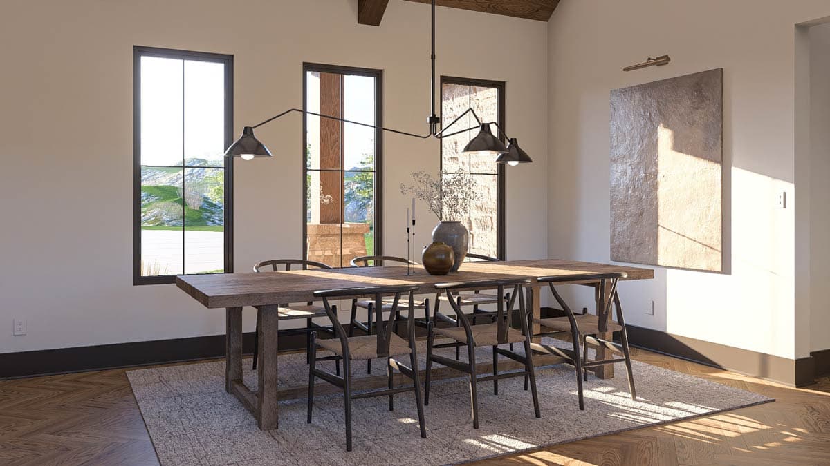 Dining room with wooden table, wishbone chairs, large windows, vaulted ceiling with exposed beams, and modern chandelier.