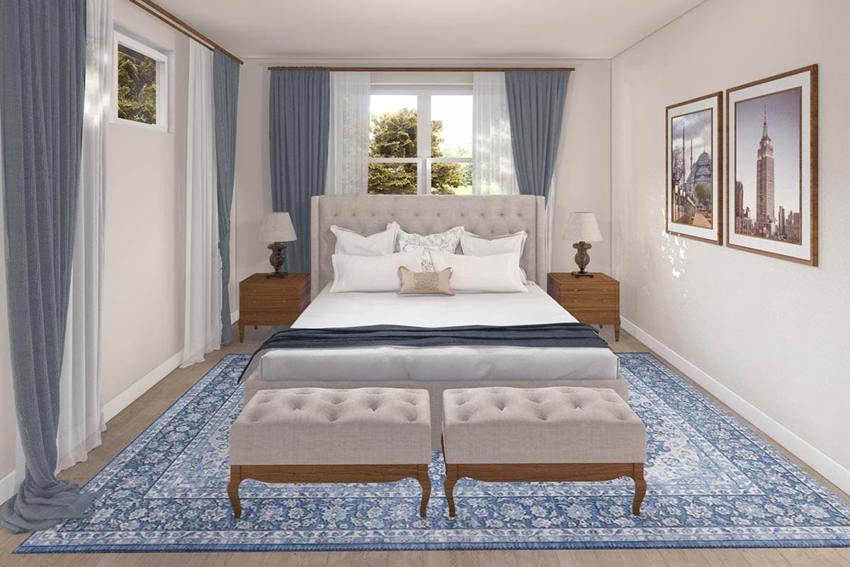 Bedroom with a tufted headboard bed, blue patterned rug, two nightstands, and framed cityscape art.