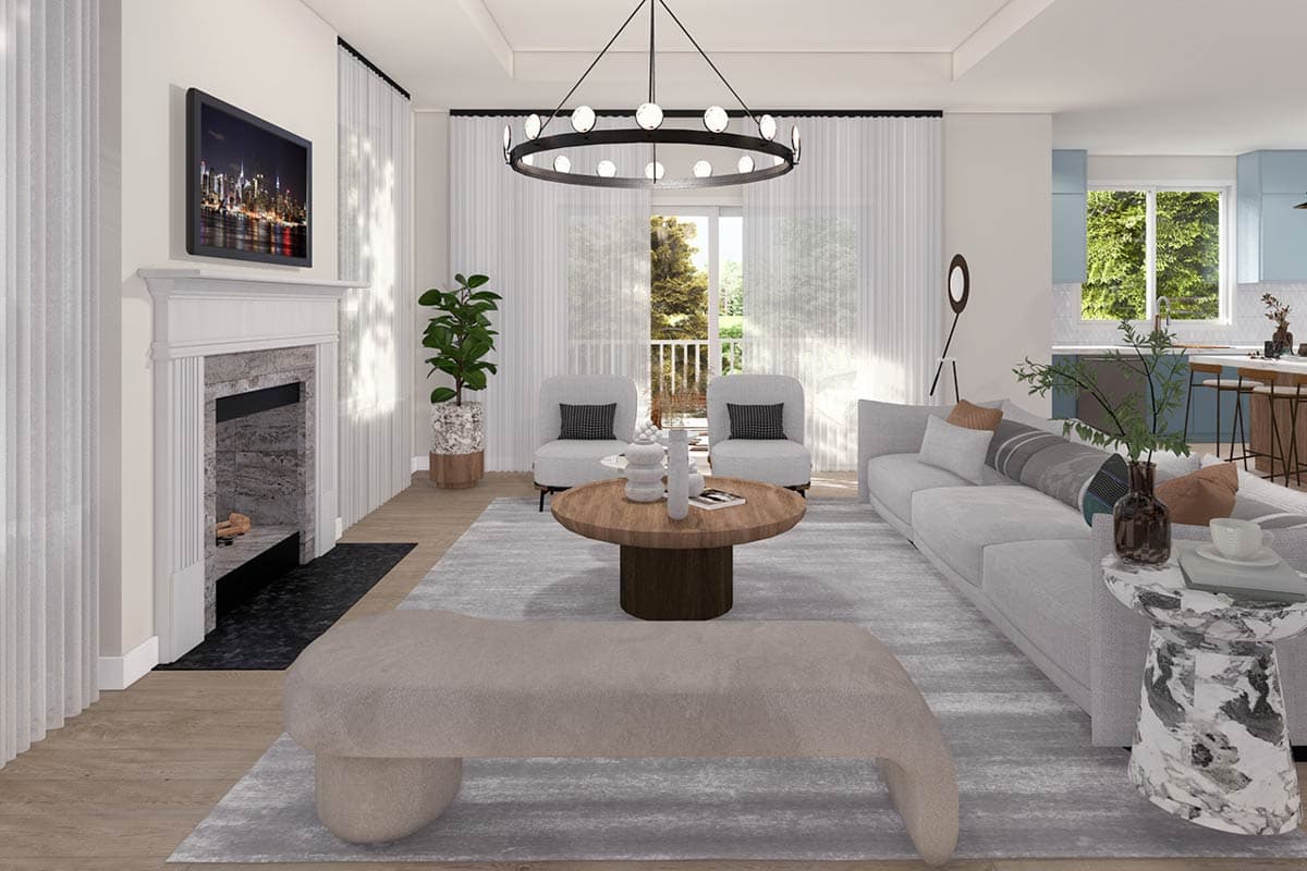 Living room with fireplace, large sectional sofa, round coffee table, and kitchen area visible.