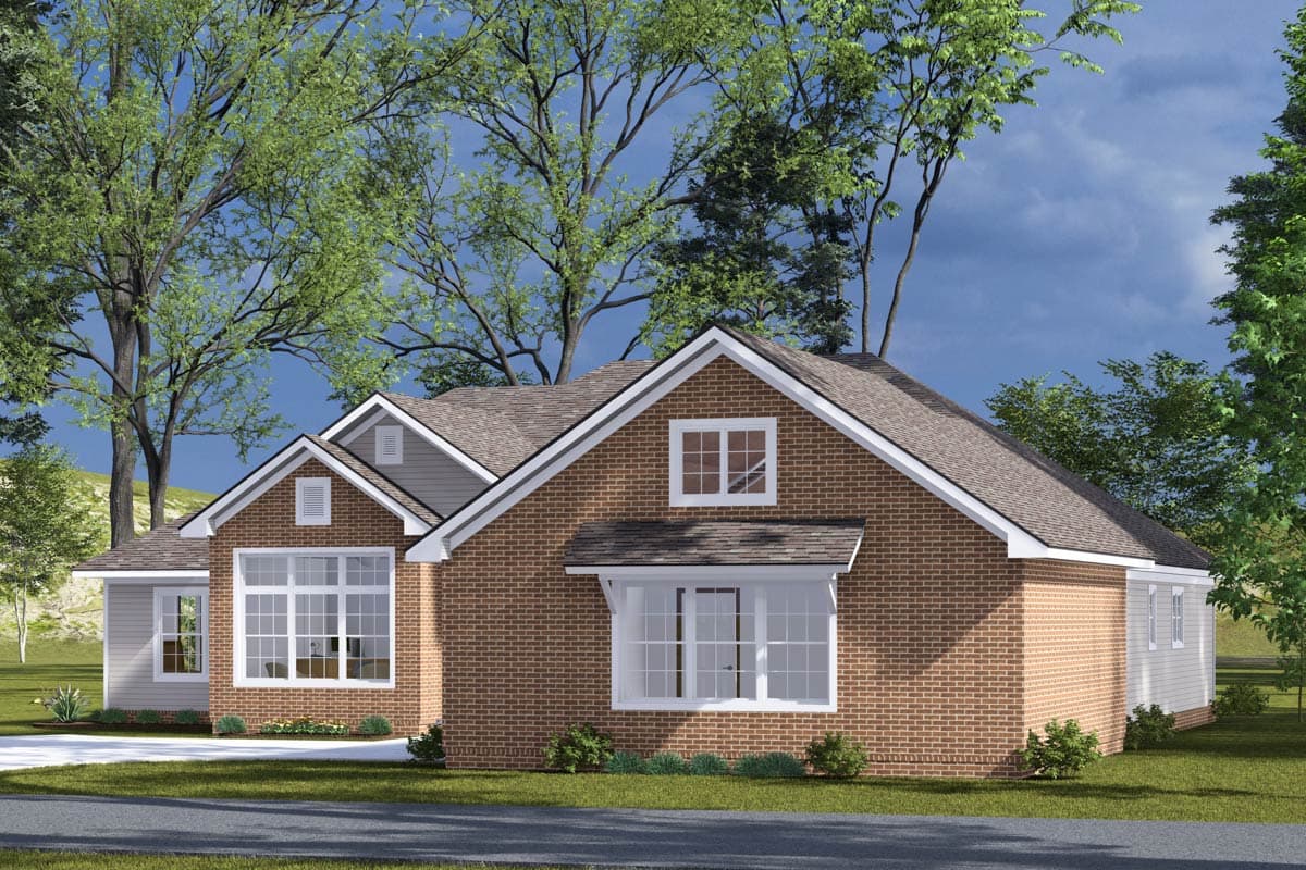 House plan exterior: One-story brick home with gables, dormers, large bay windows, and a prominent roofline.
