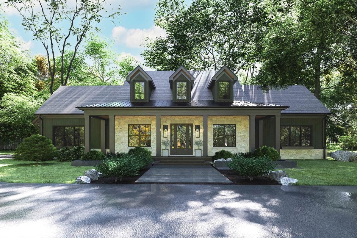 A modern house with a stone and wood facade, featuring three dormer windows. The house is surrounded by green trees and a paved driveway.